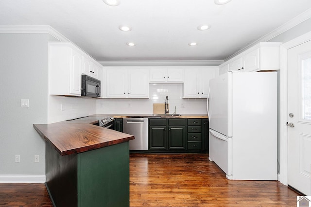 kitchen featuring appliances with stainless steel finishes, dark hardwood / wood-style flooring, white cabinetry, and sink