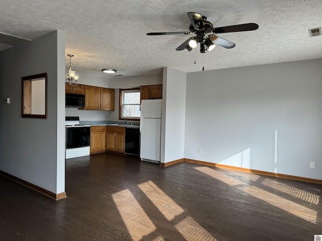 kitchen featuring decorative light fixtures, sink, dark hardwood / wood-style flooring, and black appliances