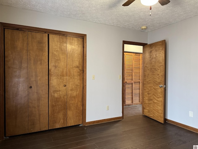 unfurnished bedroom with a textured ceiling, ceiling fan, and dark hardwood / wood-style flooring