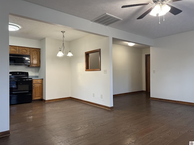 interior space with ceiling fan with notable chandelier, a textured ceiling, black appliances, dark wood-type flooring, and hanging light fixtures