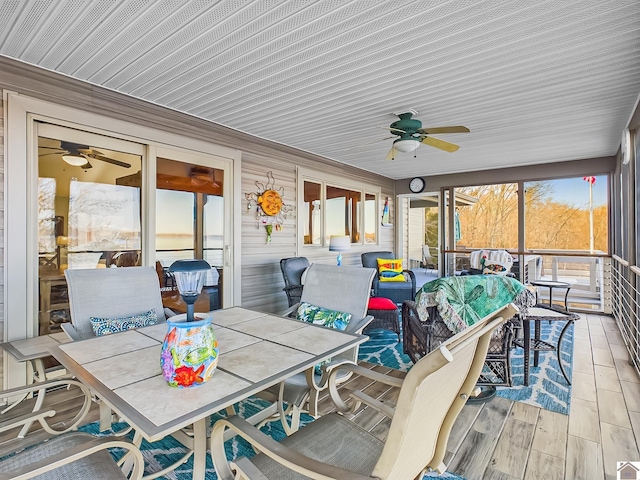 sunroom featuring ceiling fan