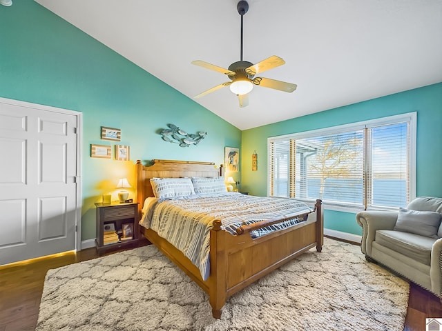 bedroom featuring ceiling fan, lofted ceiling, and wood-type flooring