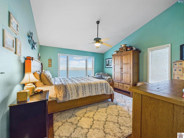 bedroom featuring ceiling fan, wood-type flooring, and lofted ceiling