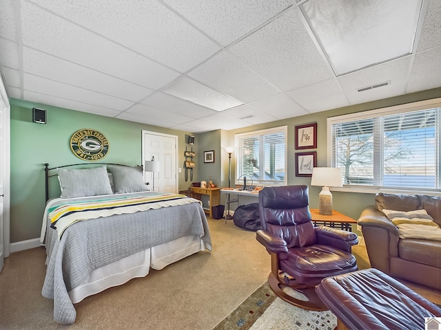 carpeted bedroom featuring a paneled ceiling