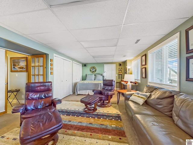 living room with a drop ceiling