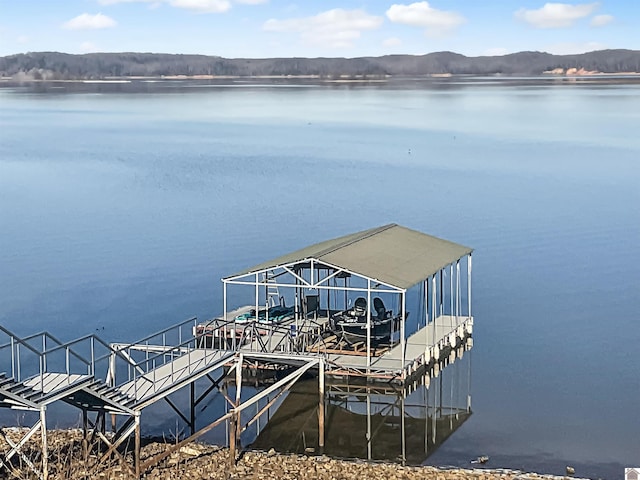 view of dock with a water and mountain view