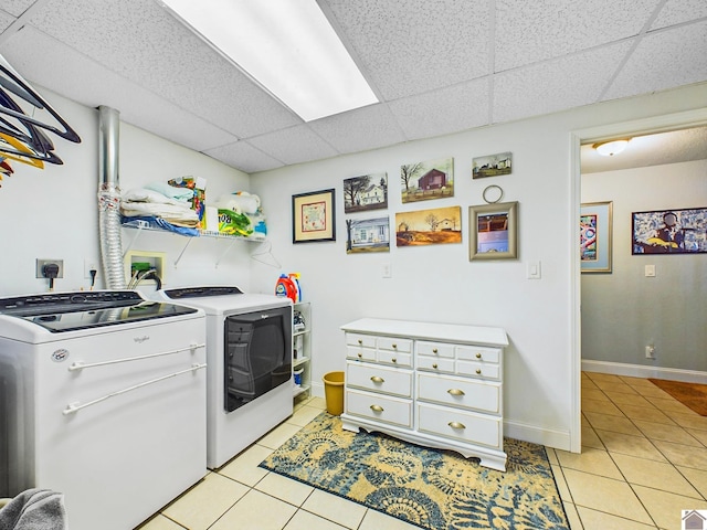 laundry area with light tile patterned floors and washing machine and dryer