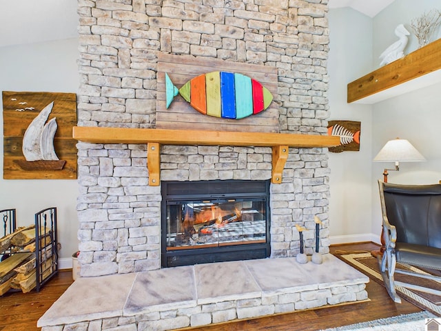 details featuring hardwood / wood-style floors and a stone fireplace