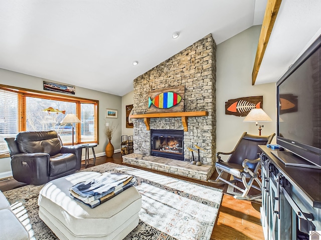 living room with lofted ceiling, a fireplace, and light hardwood / wood-style flooring