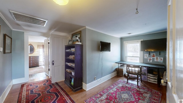 interior space with wood-type flooring and ornamental molding