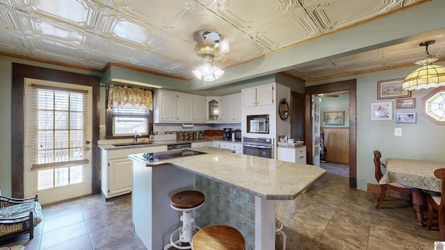 kitchen with white cabinetry, stainless steel appliances, and a kitchen island