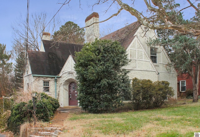 tudor home with a front yard