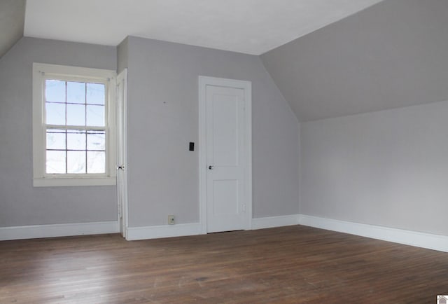 additional living space with dark hardwood / wood-style flooring and lofted ceiling