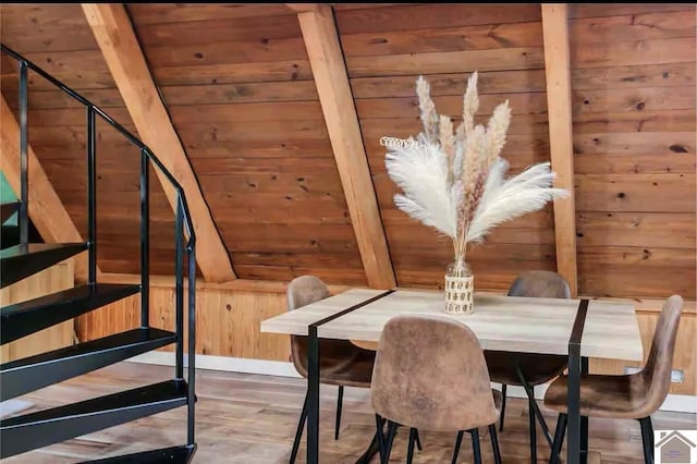 unfurnished dining area with wood ceiling, wood-type flooring, and wood walls