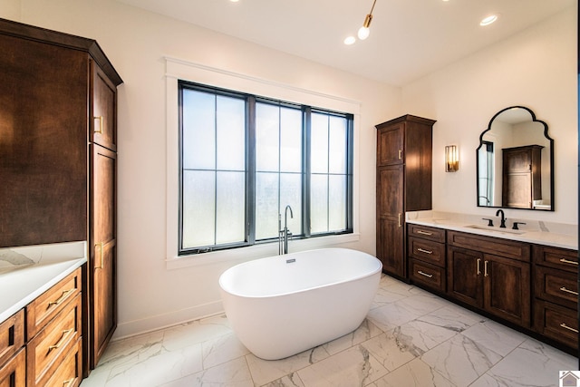 bathroom with a tub to relax in and vanity