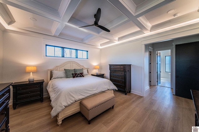 bedroom featuring hardwood / wood-style flooring, ceiling fan, coffered ceiling, and beamed ceiling