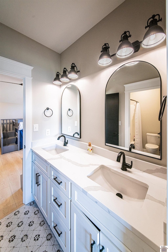 bathroom featuring toilet and vanity