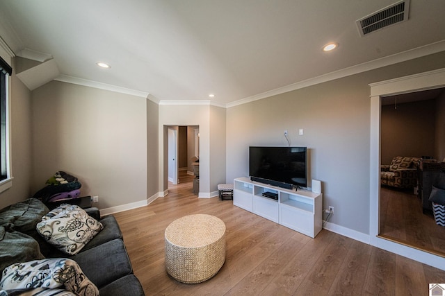 living room with ornamental molding and light hardwood / wood-style floors