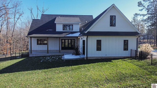 back of house with a lawn