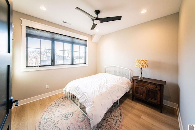 bedroom with ceiling fan and light hardwood / wood-style floors