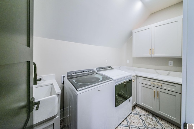 laundry room with washer and clothes dryer, sink, and cabinets