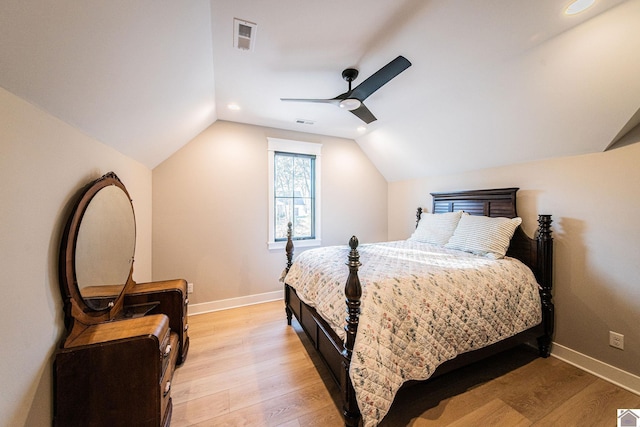 bedroom with ceiling fan, light hardwood / wood-style floors, and vaulted ceiling