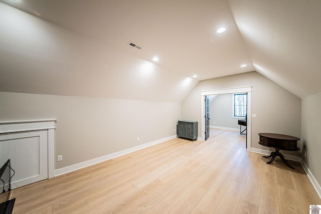 bonus room with vaulted ceiling and light hardwood / wood-style floors