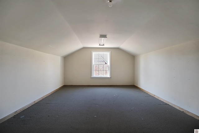 bonus room featuring lofted ceiling and carpet flooring