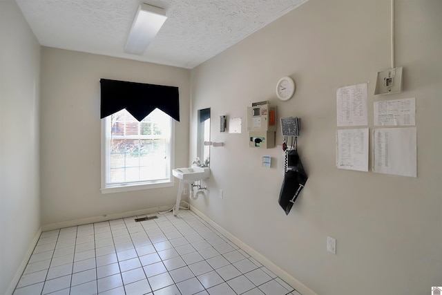 tiled foyer entrance with a textured ceiling