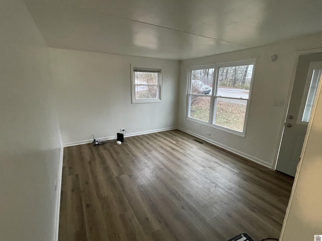 spare room with dark hardwood / wood-style flooring