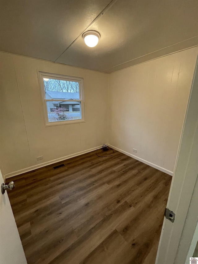 empty room featuring dark wood-type flooring