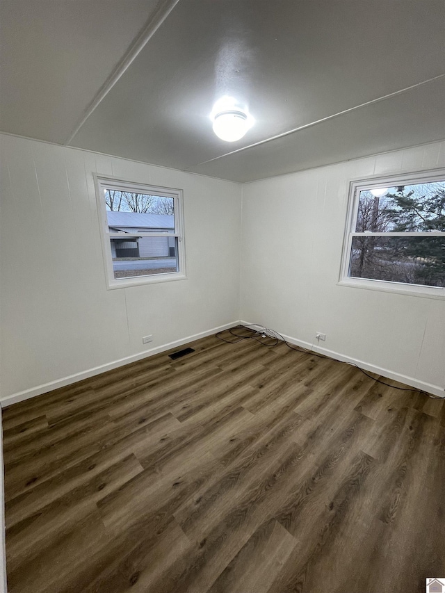 unfurnished room with dark hardwood / wood-style floors