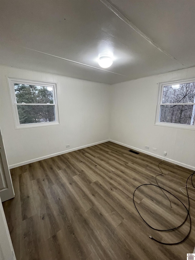 spare room with dark hardwood / wood-style flooring