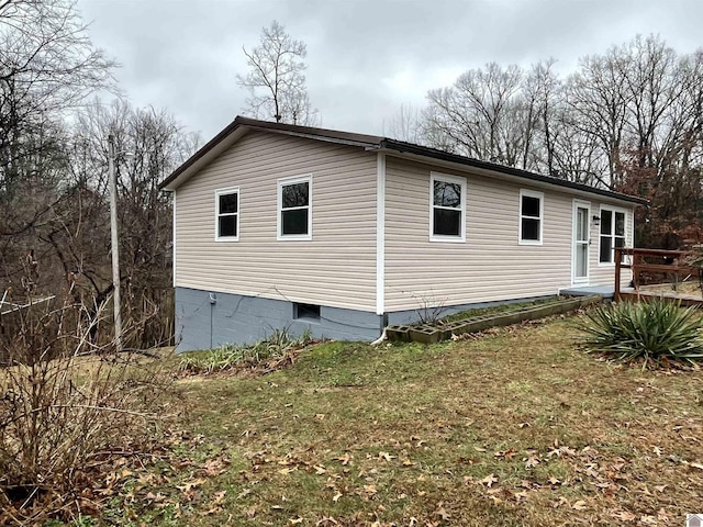 view of side of property with a yard