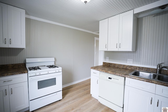 kitchen featuring white cabinetry, sink, white appliances, and light hardwood / wood-style flooring