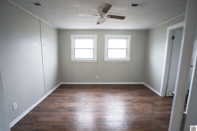 empty room featuring ceiling fan, dark wood-type flooring, and ornamental molding