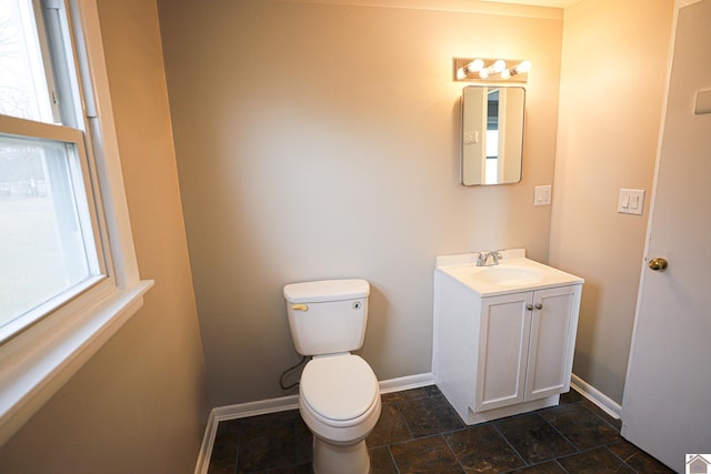 bathroom featuring toilet and vanity