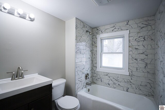 full bathroom with toilet, tiled shower / bath combo, and vanity