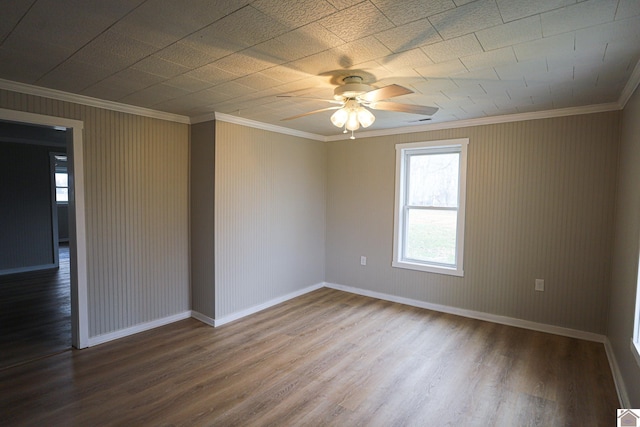 spare room featuring ceiling fan, crown molding, and wood-type flooring