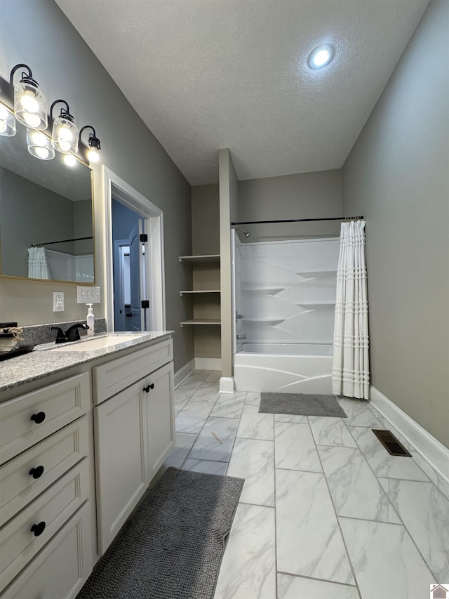 bathroom featuring a textured ceiling, vanity, and shower / bath combo