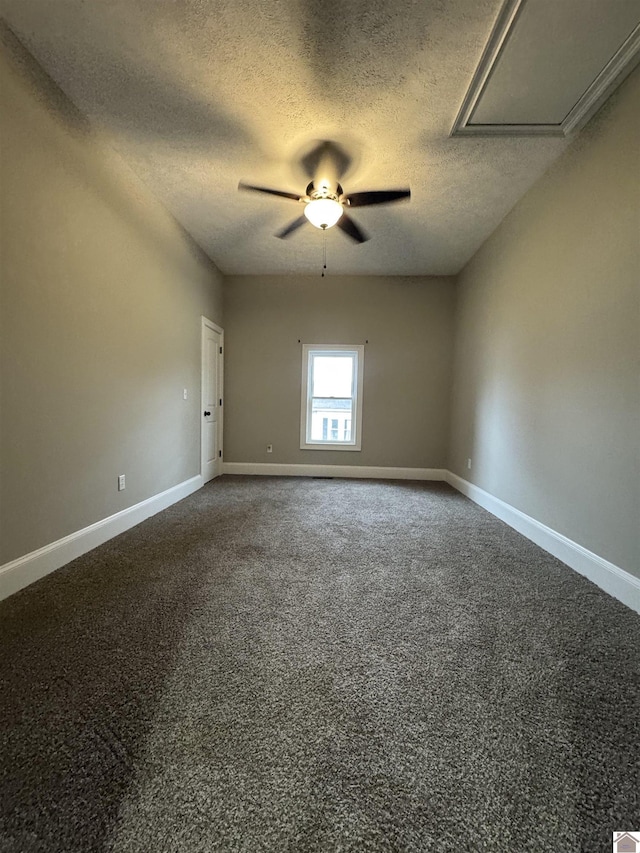 unfurnished room with ceiling fan and a textured ceiling