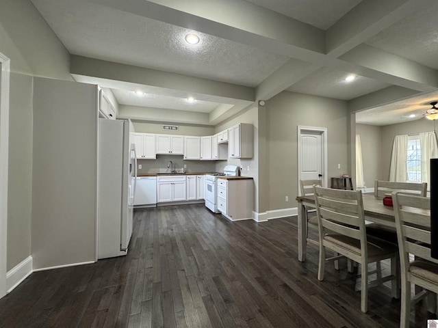 kitchen featuring white appliances, white cabinetry, beamed ceiling, sink, and dark hardwood / wood-style floors