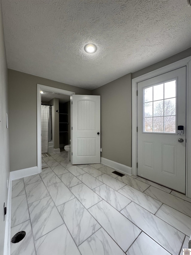 foyer featuring a textured ceiling