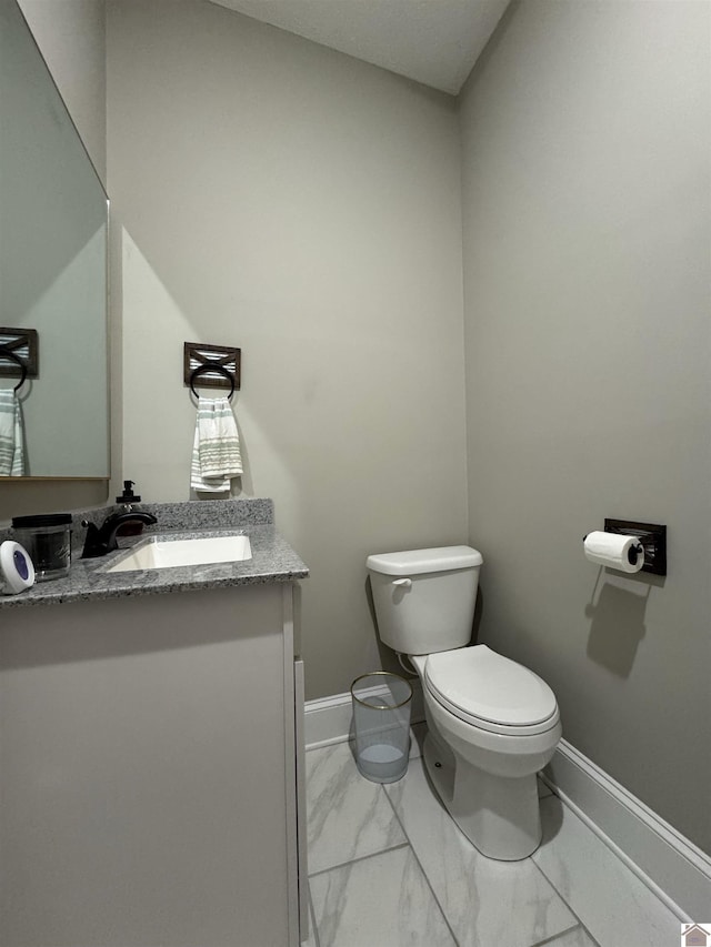 bathroom featuring toilet and vanity