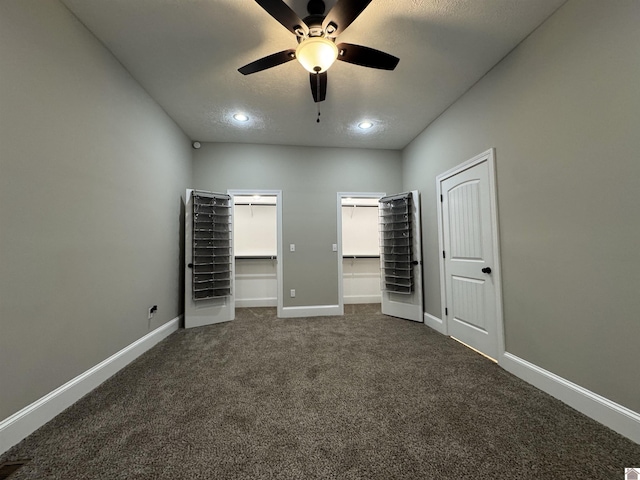 unfurnished bedroom with ceiling fan and dark colored carpet