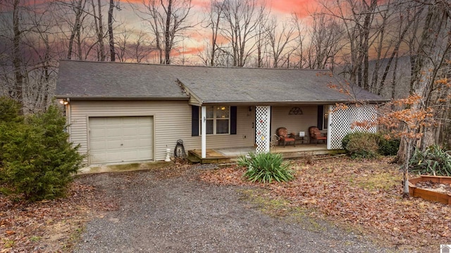 single story home with covered porch and a garage