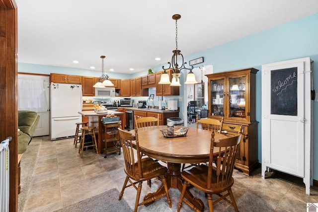 dining area featuring a notable chandelier and sink