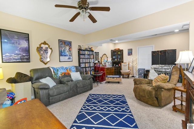 living room featuring ceiling fan and carpet