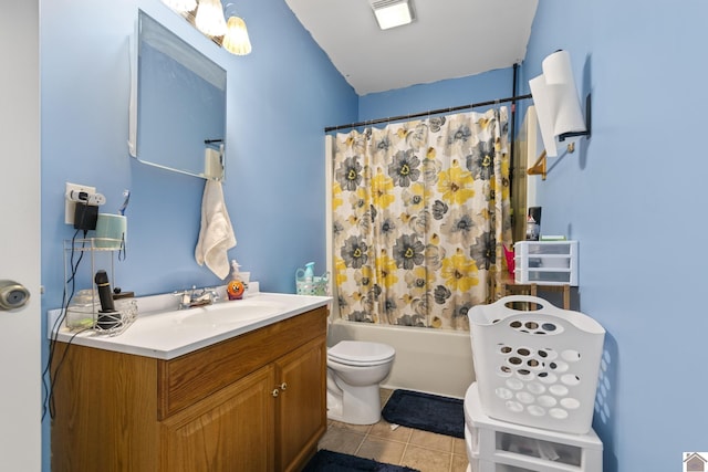 full bathroom with toilet, tile patterned floors, vanity, and shower / bath combo with shower curtain