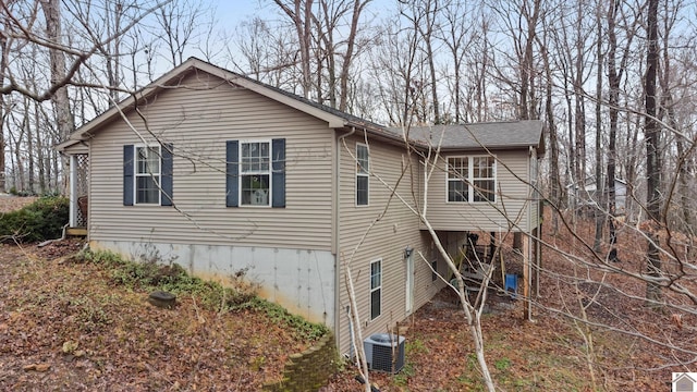 rear view of house featuring central AC unit